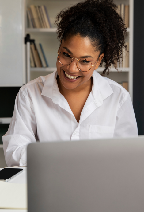 Smiling freelancer working on a laptop